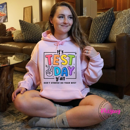 Cozy Light Pink hoodie with colorful test day peace sign design.