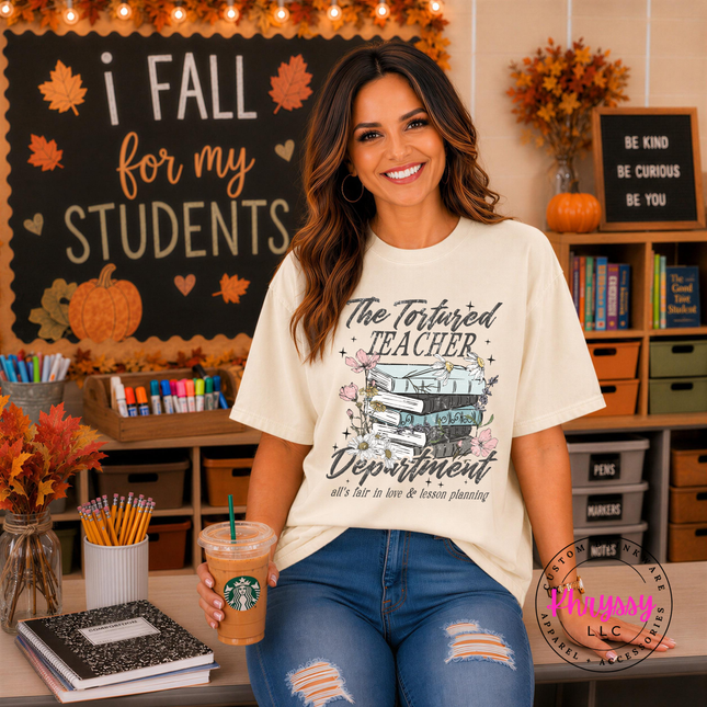 Ivory tee with The Tortured Teacher Department script and floral books.
