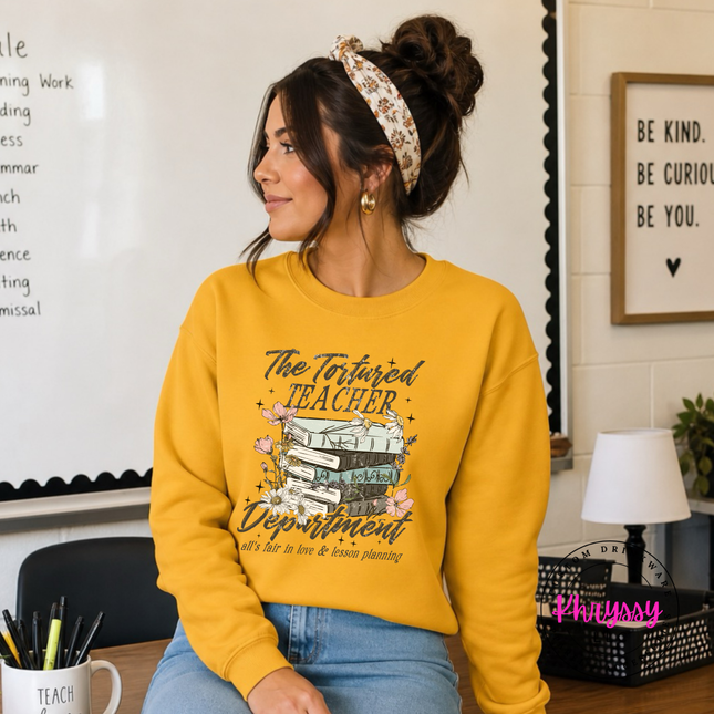 Gold crewneck sweatshirt with moody literary teacher lettering.
