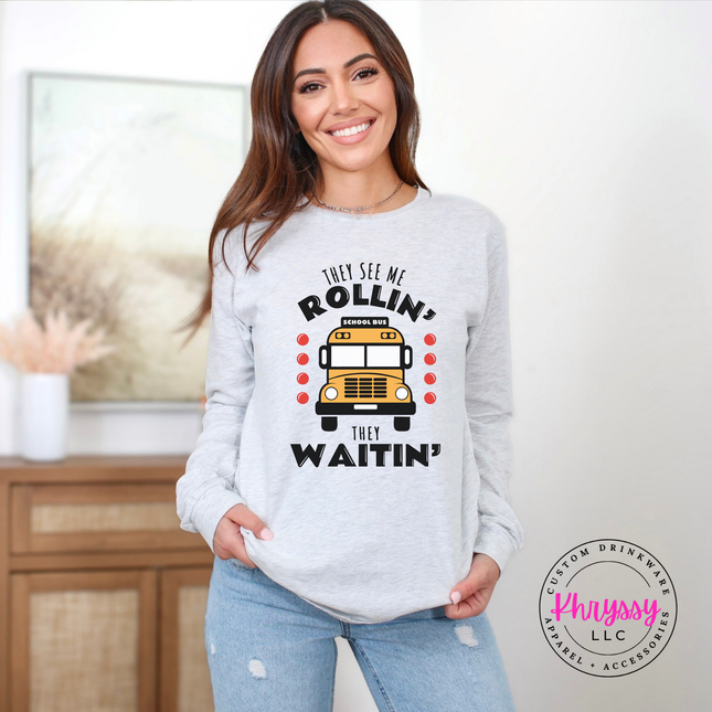 Woman wearing an Ash tee with a funny school bus driver graphic.