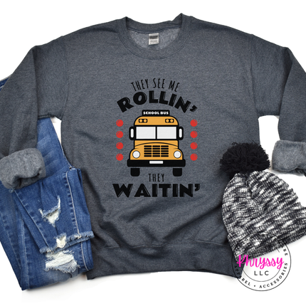 Dark heather crewneck sweatshirt featuring the funny They See Me Rollin quote.