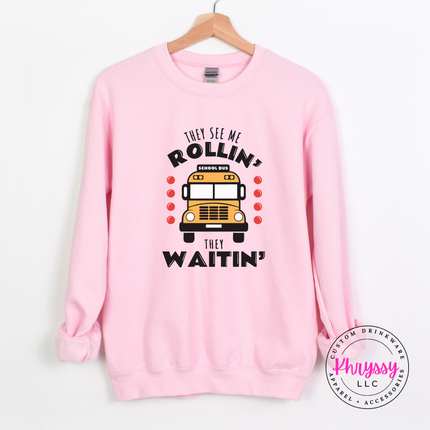 Light Pink crewneck sweatshirt styled with jeans, showing the bus print design.