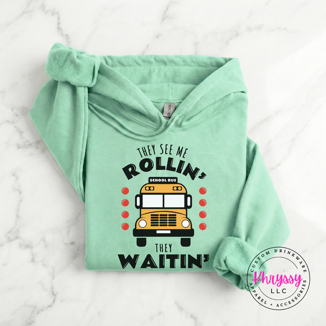 Mint Green hoodie styled with jeans, showing the colorful bus design.