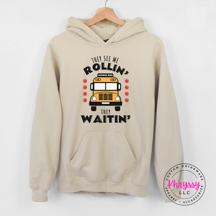 Sand hoodie flat lay with the playful school bus driver quote.