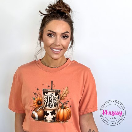 Terracotta tee featuring a cow print tumbler, football, and pumpkin collage.