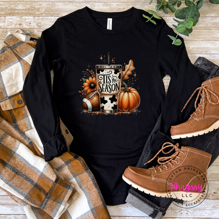 Black tee styled with jeans, featuring a cow print tumbler graphic.