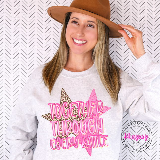 Woman wearing an Ash crewneck sweatshirt with the together through every battle design