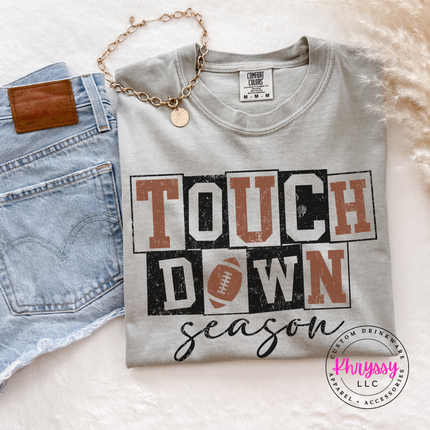Graphite tee featuring retro block letters and a football icon.