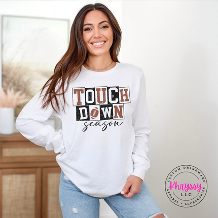 White tee styled with jeans, featuring retro football block type.