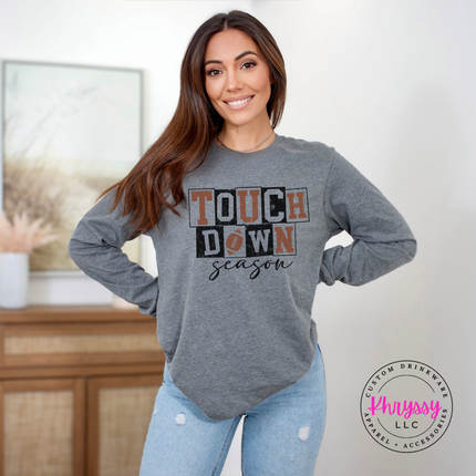 Dark heather colored top with a hand-illustrated touchdown season graphic.