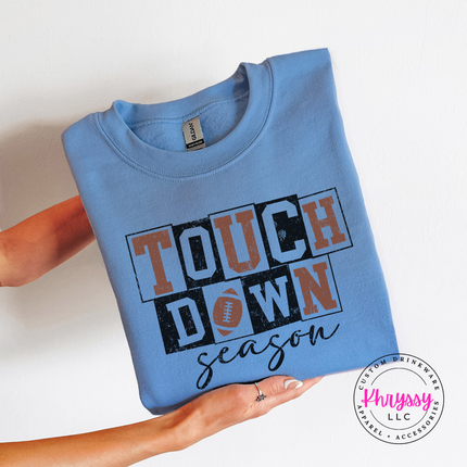 Carolina Blue crewneck sweatshirt with the Touchdown Season football graphic