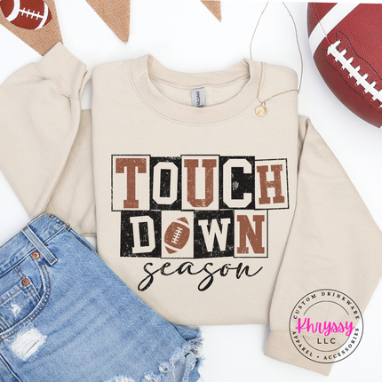 Sand crewneck sweatshirt featuring retro block letters and a football.