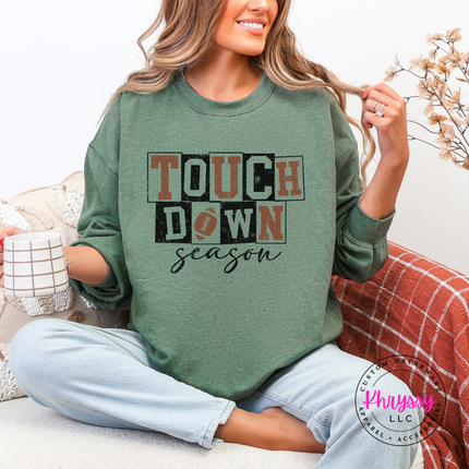 Heather sport dark green crewneck sweatshirt with a hand-illustrated touchdown season graphic.
