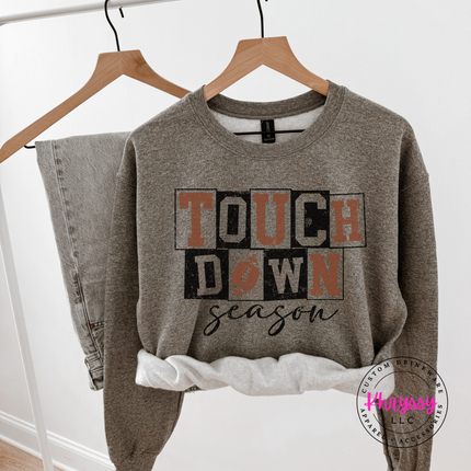 Graphite heather colored crewneck sweatshirt featuring retro football block type.