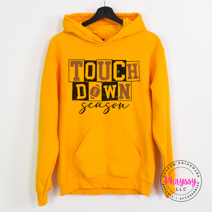Gold pullover hoodie with a bold touchdown season illustration.