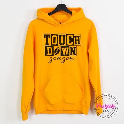 Gold hoodie with the football season block letter print