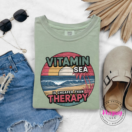 Bay green beach tee featuring a vintage sunset and ocean wave print.