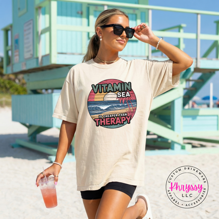 Ivory beach lover tee with a distressed vintage ocean scene graphic.