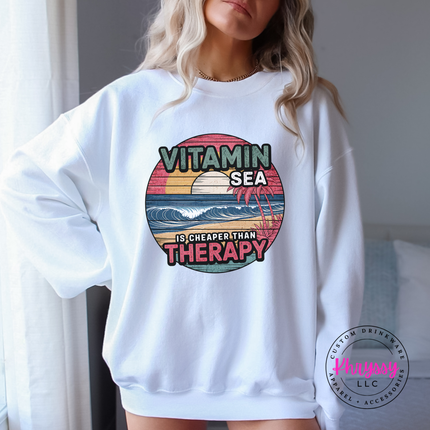 White Gildan crewneck sweatshirt with a retro Vitamin Sea beach print.