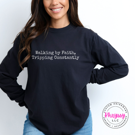 Black long sleeve tee with the Walking By Faith, Tripping Constantly quote