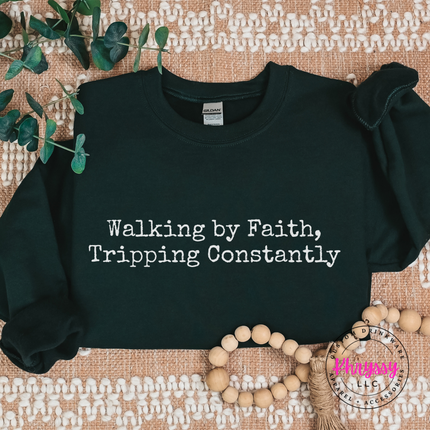 Flat lay of a forest green crewneck featuring playful Christian typography.