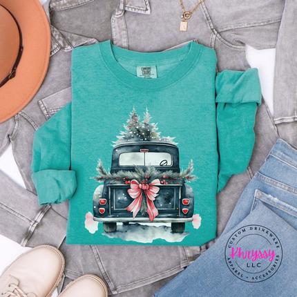 Close up of the watercolor Christmas truck art on a Seafoam long sleeve tee.