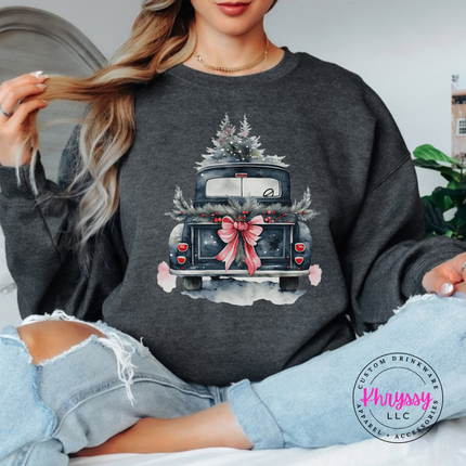 Close up of the watercolor Christmas truck art on a Dark Heather crewneck sweatshirt.
