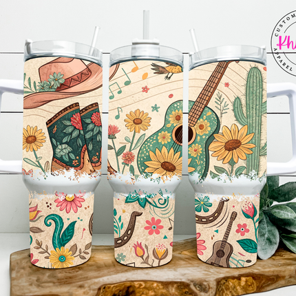 Set of tumblers with cowboy boot, guitar, and cactus designs on a wooden stand.