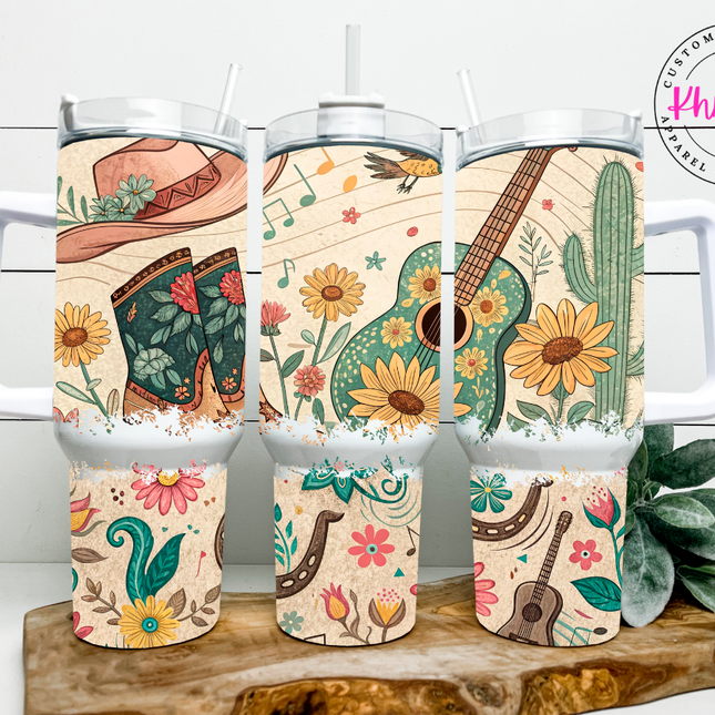 Set of tumblers with cowboy boot, guitar, and cactus designs on a wooden stand.