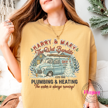 Mustard Comfort Colors tee featuring a snowy cabin and van in a retro holiday badge.
