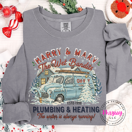 Flat lay of a Gray long sleeve tee with a funny plumbing and heating graphic.