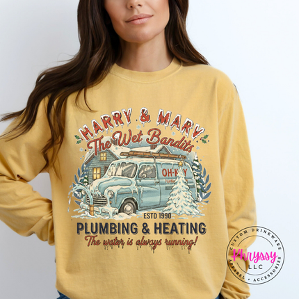 Mustard long sleeve tee featuring a snowy cabin and van in a retro holiday badge.