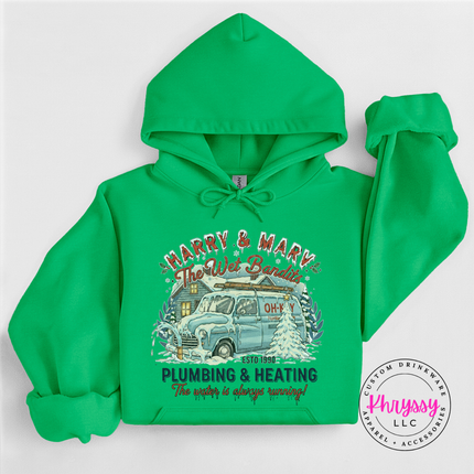 Flat lay of an Irish Green pullover hoodie with a funny plumbing and heating graphic.