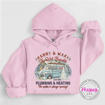 Light Pink pullover hoodie with a nostalgic Christmas plumbing badge, front view.