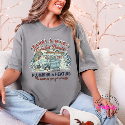 Flat lay of a Gray Comfort Colors tee with a funny plumbing and heating graphic.