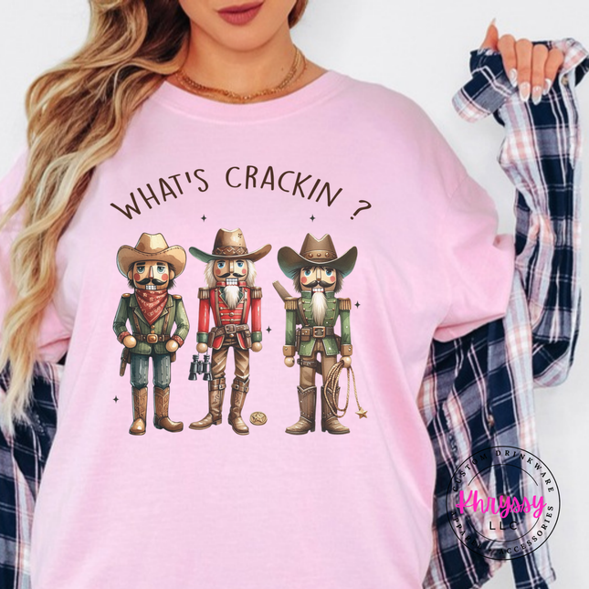 Blossom tee featuring three cowboy nutcrackers and What's Crackin lettering.
