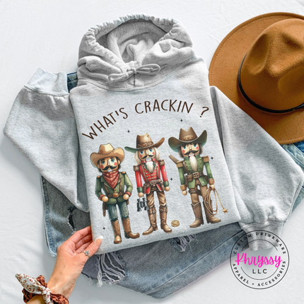 Ash hoodie featuring three cowboy nutcrackers and What's Crackin lettering.
