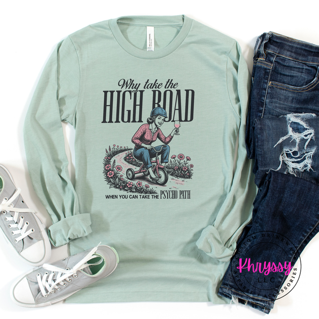 Light green long-sleeve shirt with graphic design and text, paired with jeans and sneakers on a white background.