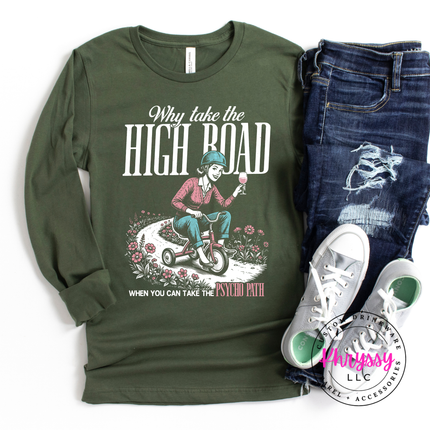 Green long-sleeve shirt with graphic design and text, paired with jeans and sneakers on a white background.