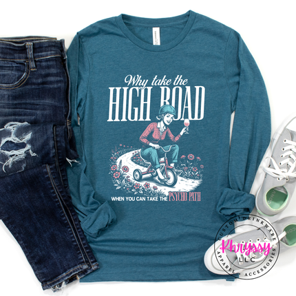 Blue long-sleeve shirt with graphic design and text, paired with jeans and sneakers on a white background.