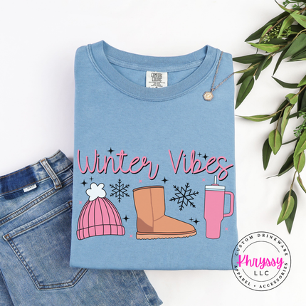 Ice Blue long sleeve tee with Winter Vibes script, beanie, boot and tumbler.