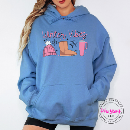 Cozy Winter Vibes beanie, boot and tumbler design on a Carolina Blue hoodie.