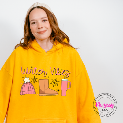Woman wearing the Winter Vibes hoodie in Gold.