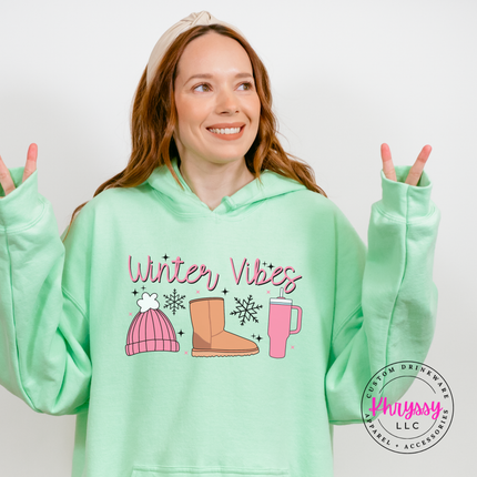 Close up of the Winter Vibes script and snowflakes on a Mint Green hoodie.