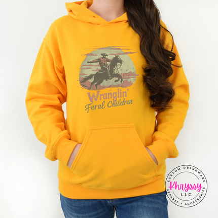 Gold hoodie with funny western feral children lettering.