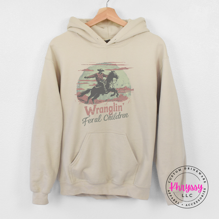 Sand hoodie showing a muted vintage cowboy mom graphic.
