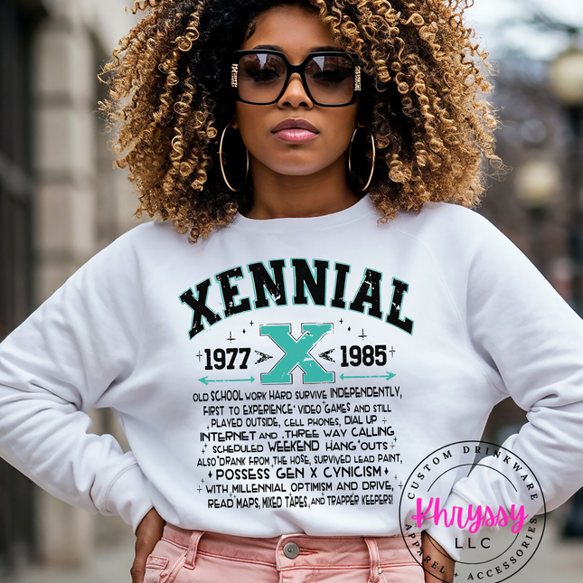 Woman wearing a white sweatshirt with 'Xennial' design, standing outdoors.